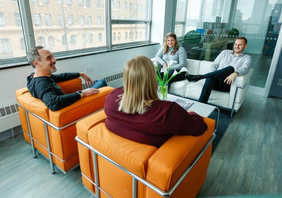 Banner image of clients sitting in a room and talking