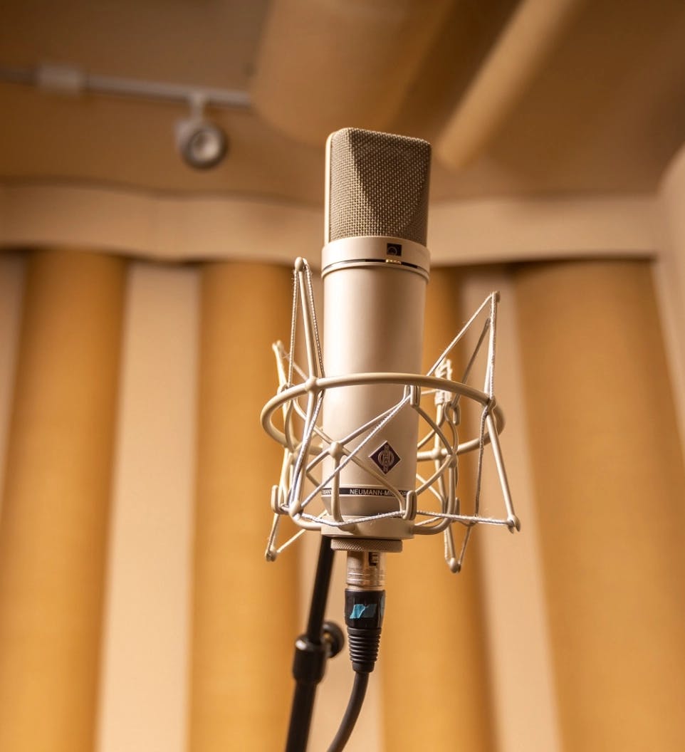 Banner image of a microphone in a studio