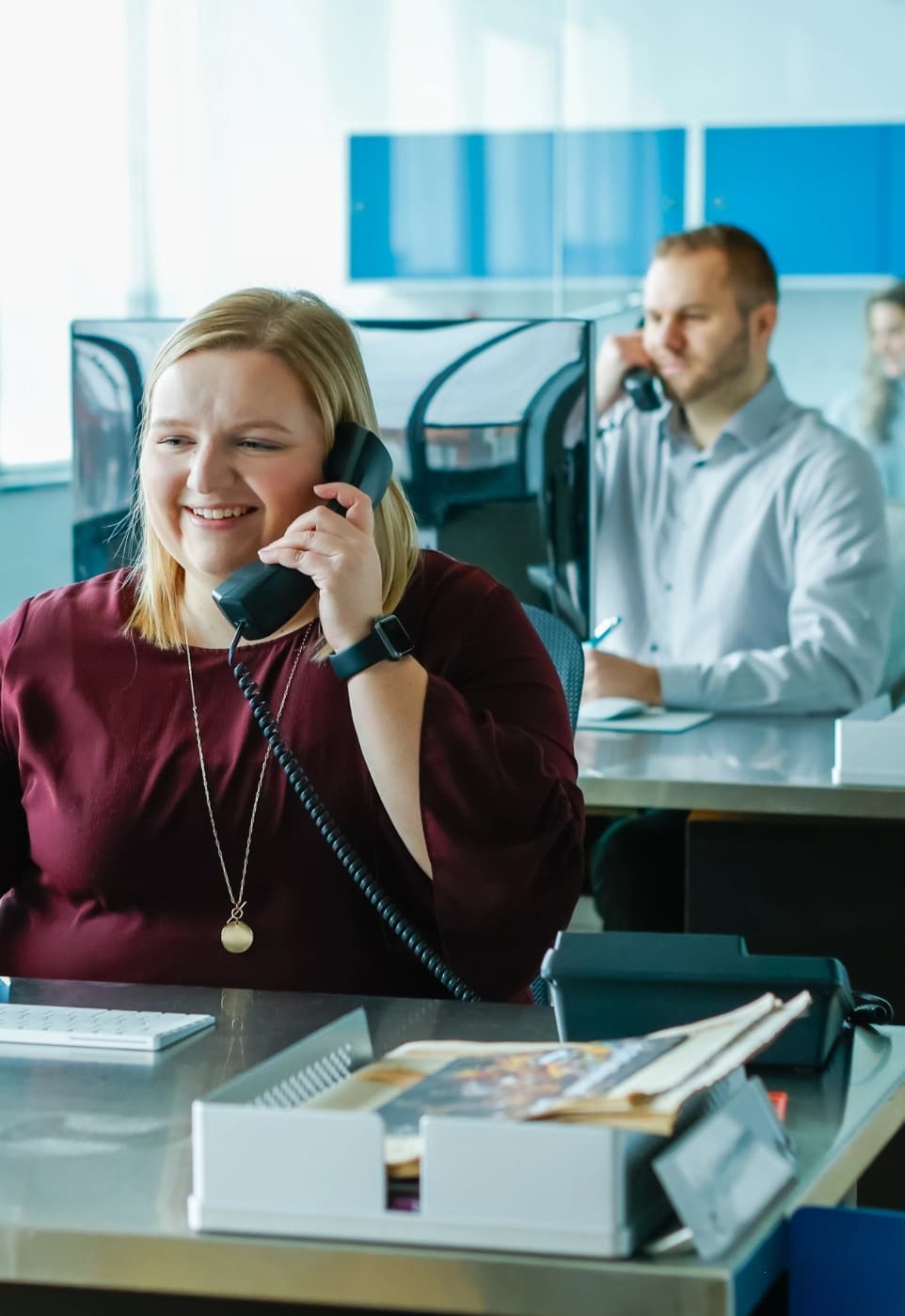 Banner Image of an office full of people on phones